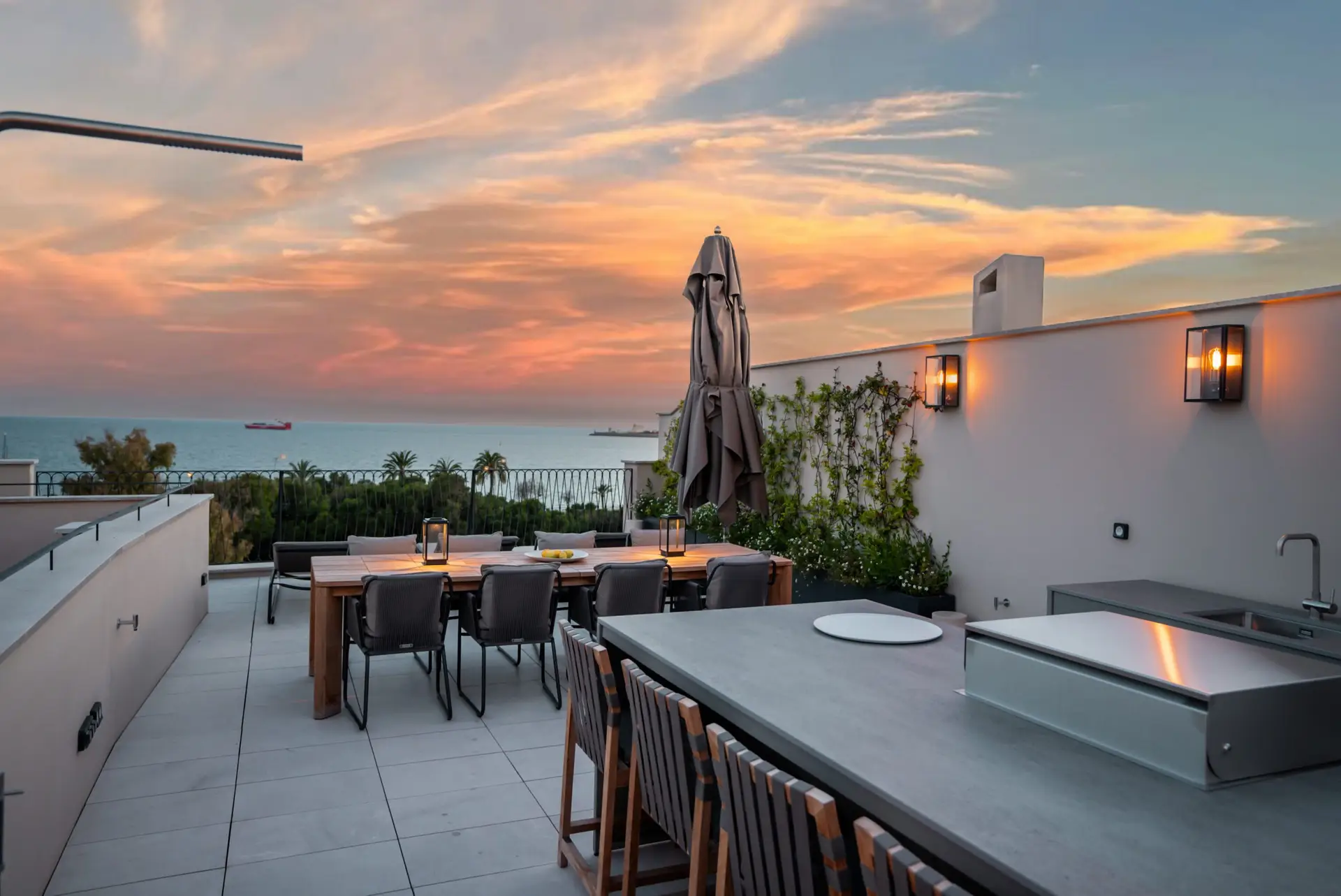 Luxury rooftop terrace with panoramic sea views at sunset in Palma Old Town, Mallorca — exclusive property represented by Isabella Janoschka
