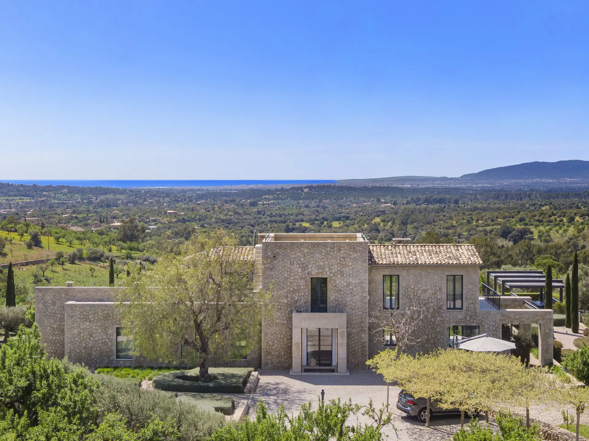 Luxury stone villa with panoramic views over Central Mallorca and the Mediterranean in Santa Maria del Camí — exclusive property represented by Isabella Janoschka