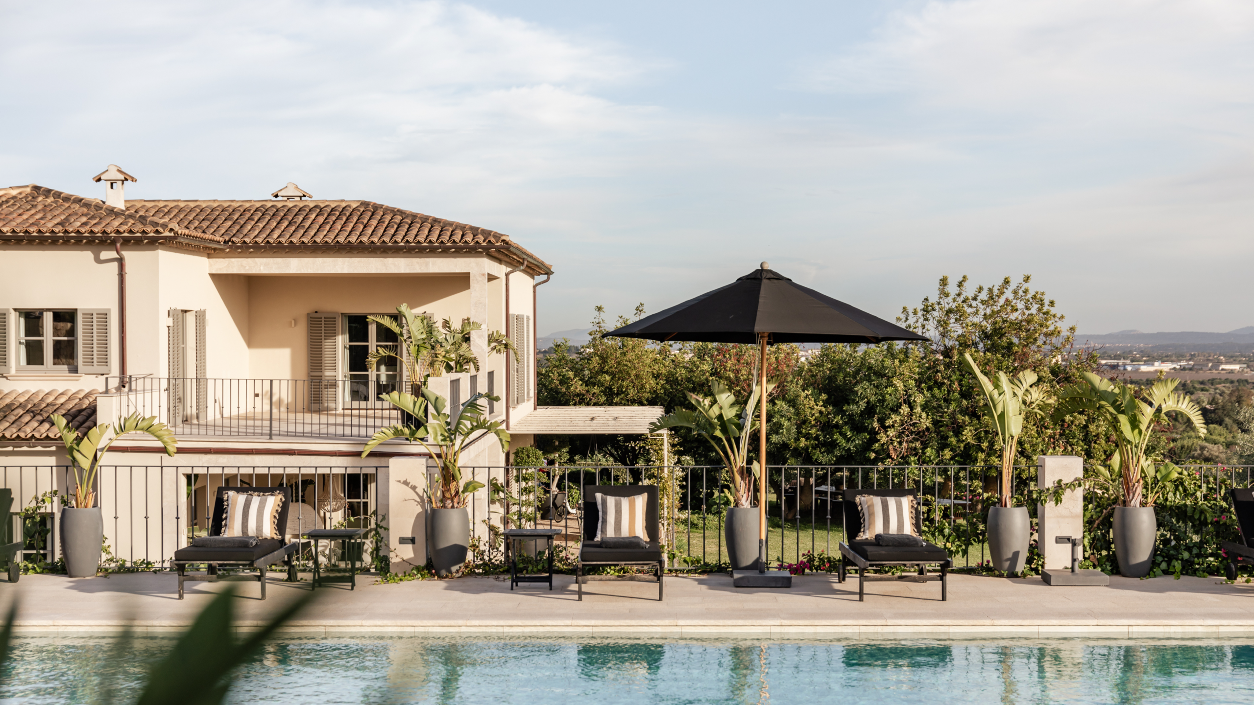 Luxury stone villa with panoramic views over Central Mallorca and the Mediterranean in Santa Maria del Camí — exclusive property represented by Isabella Janoschka