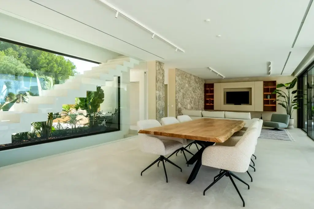 Living and dining room opening towards the pool at Nova One