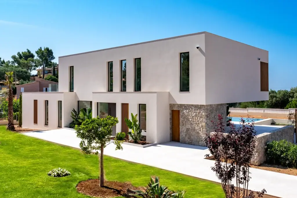 Stone facade and landscaped garden at Nova One