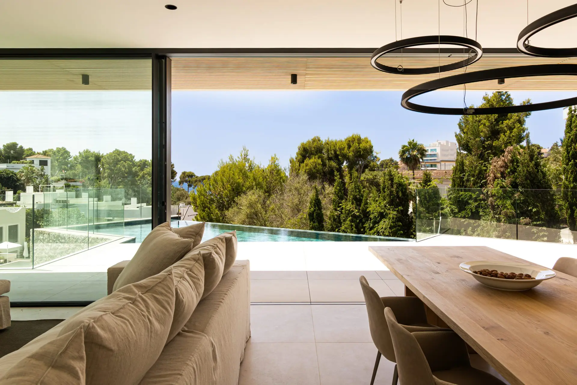 Living and dining area overlooking the pool and sea at the Old Bendinat villa