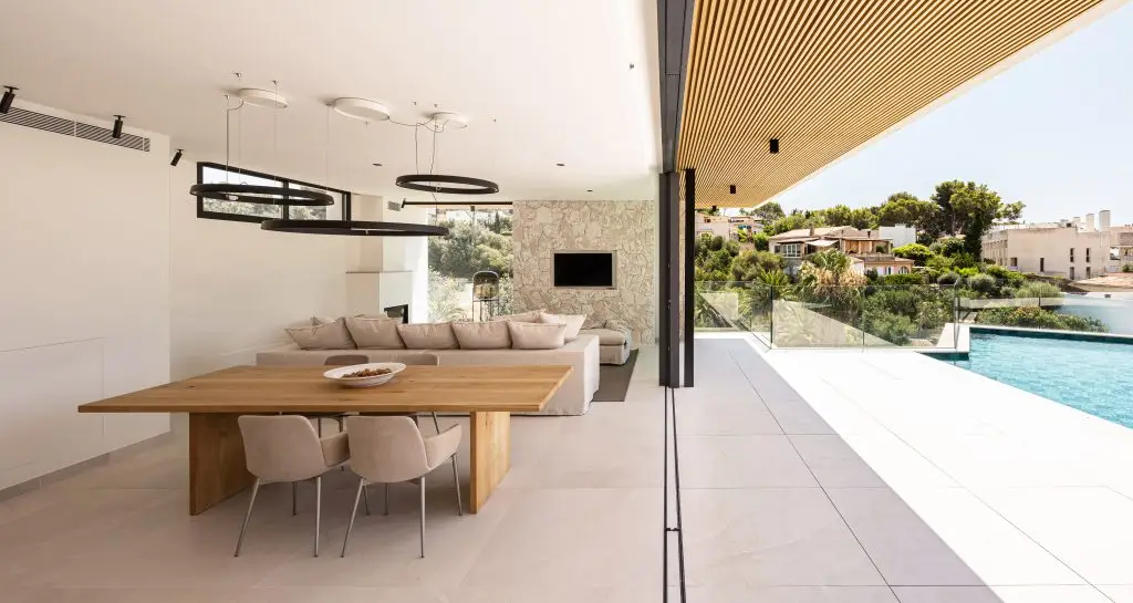 Living and dining room with doors open to the terrace at the Old Bendinat villa