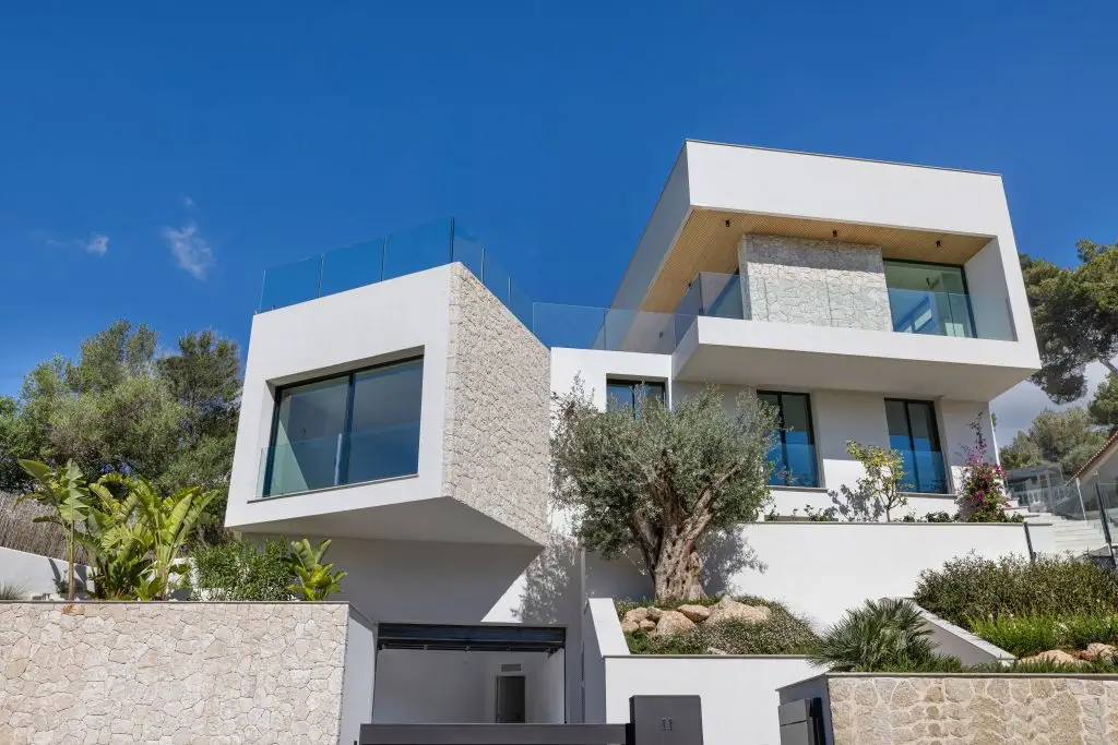 Villa exterior with stone facade and landscaped garden at the Old Bendinat villa