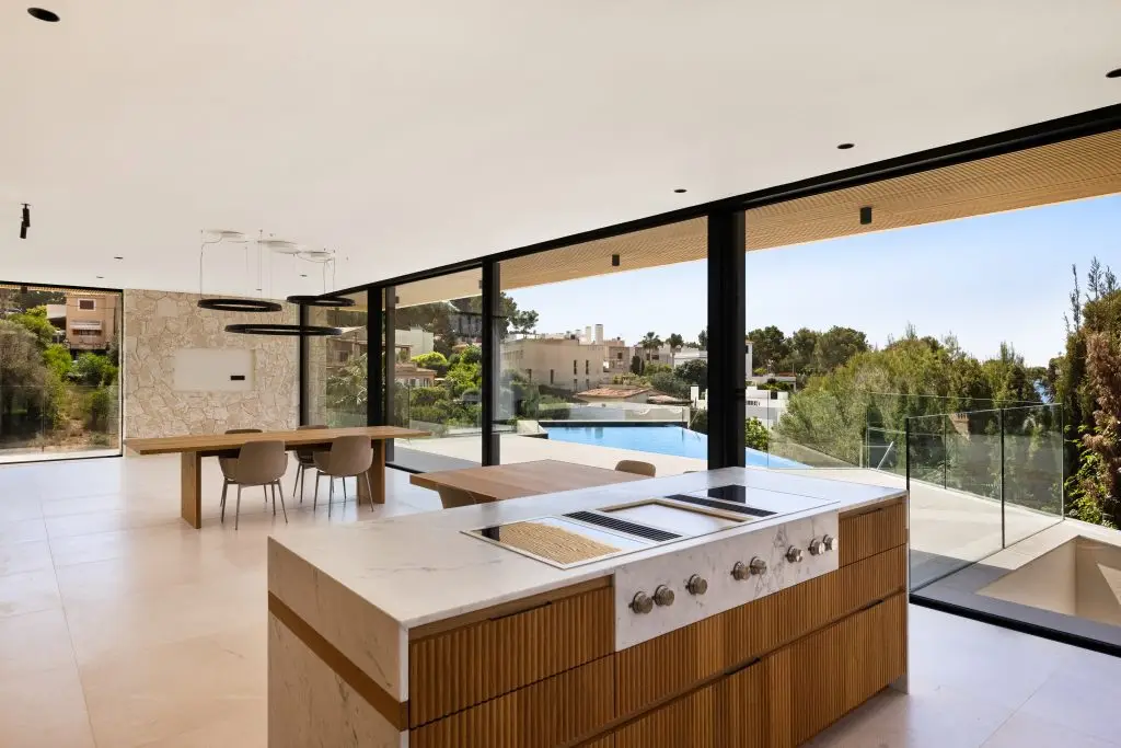 Kitchen island overlooking the dining area and pool at the Old Bendinat villa