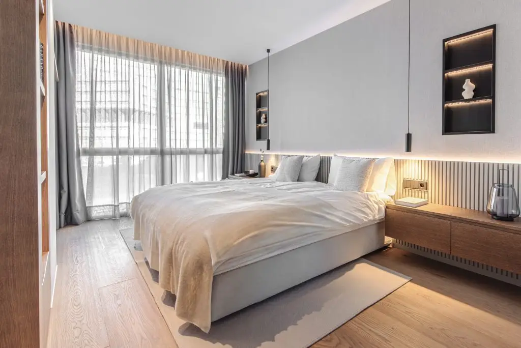 Bedroom with parquet flooring and soft lighting at the Portixol duplex
